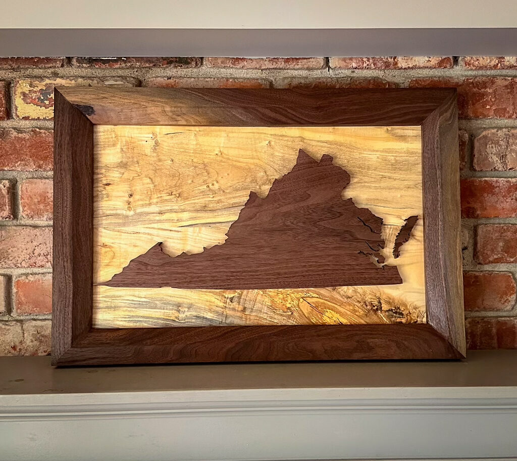 Custom state silhouette wall art — walnut state inlay on figured spalted maple, framed in walnut